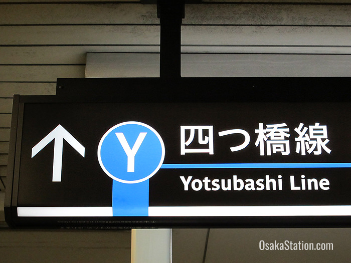 Signs for the Yotsubashi Line are color-coded blue