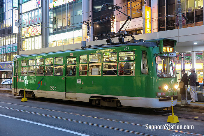 A tram taking on passengers