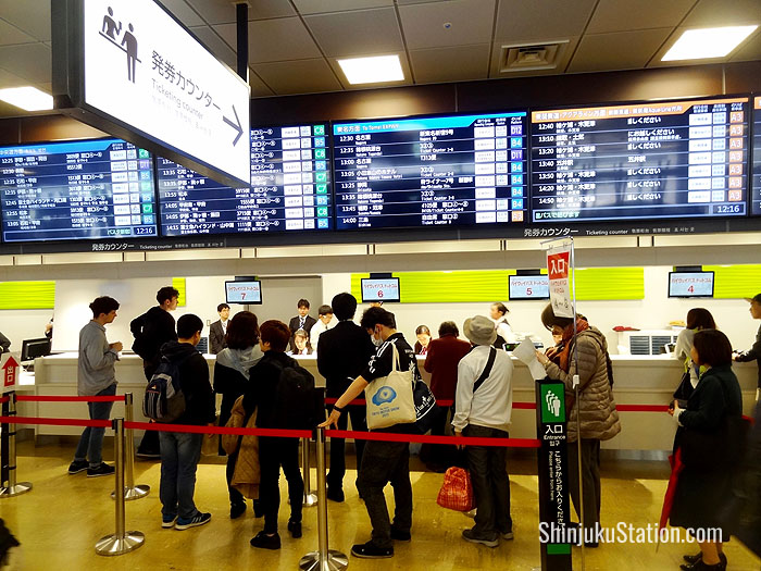 Passengers queue for tickets on the fourth floor of Basuta Shinjuku