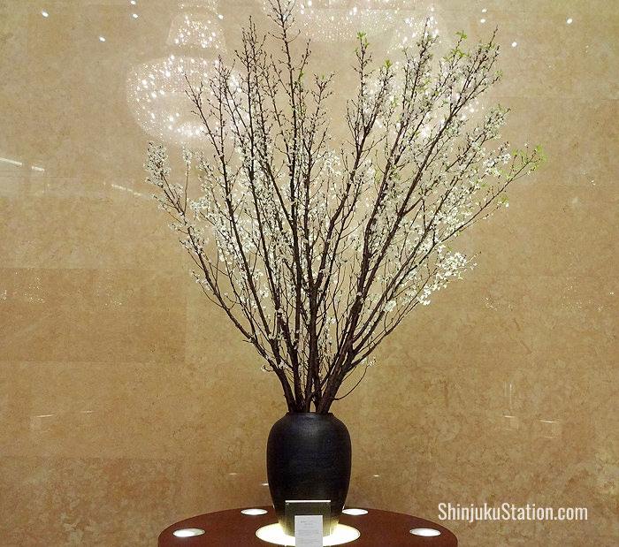 Cherry tree boughs adorn the cavernous lobby