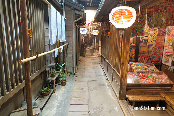 A recreated tenement alleyway with a dagashiya sweet shop on the right